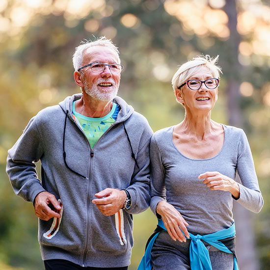 Two elderly people running