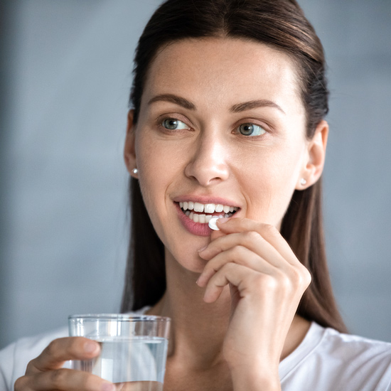 Woman takes zinc tablet